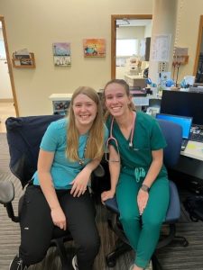 Nurses smiling at work station